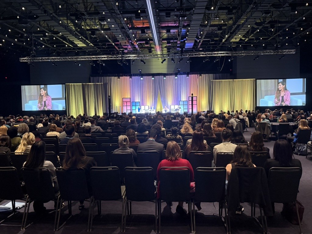 Dr. Mewawalla on stage before a full conference audience