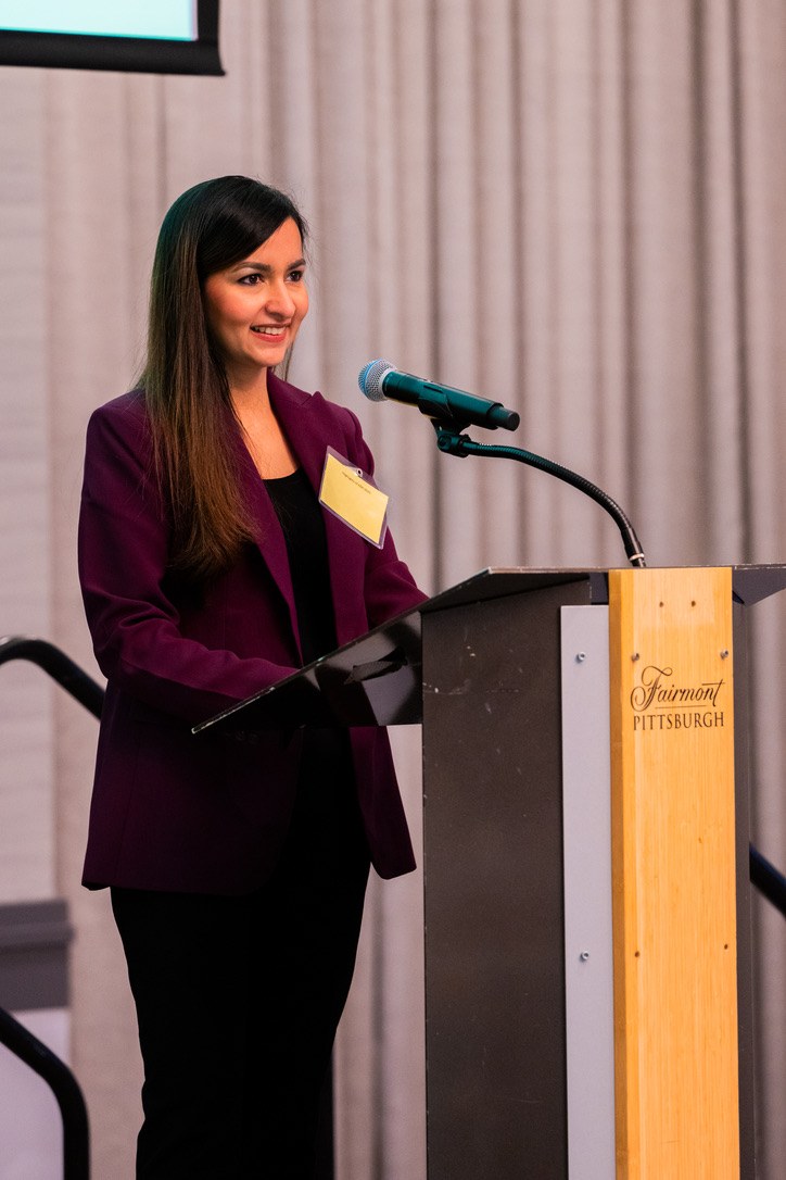 Dr. Mewawalla presenting at a podium, Fairmont Pittsburgh